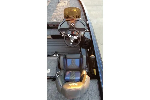 Slide: The Image of 2026 Phoenix 920 Elite X boat cockpit with steering wheel and cushioned seat. - 8
