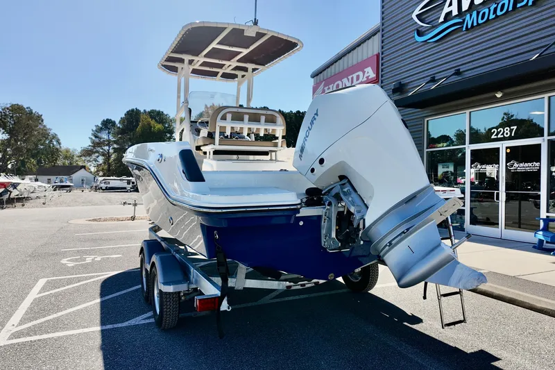 Slide: The Image of 2026 Bayliner Trophy T22CC boat on trailer outside dealership. - 3