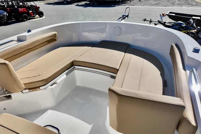 Slide: The Image of 2026 Bayliner Trophy T22CC boat interior with beige seating and spacious layout. - 4
