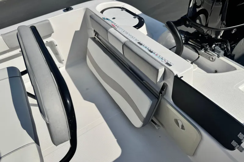 Slide: The Image of Key Largo 2001 CC boat interior, featuring seating and engine area, 2023 model. - 21