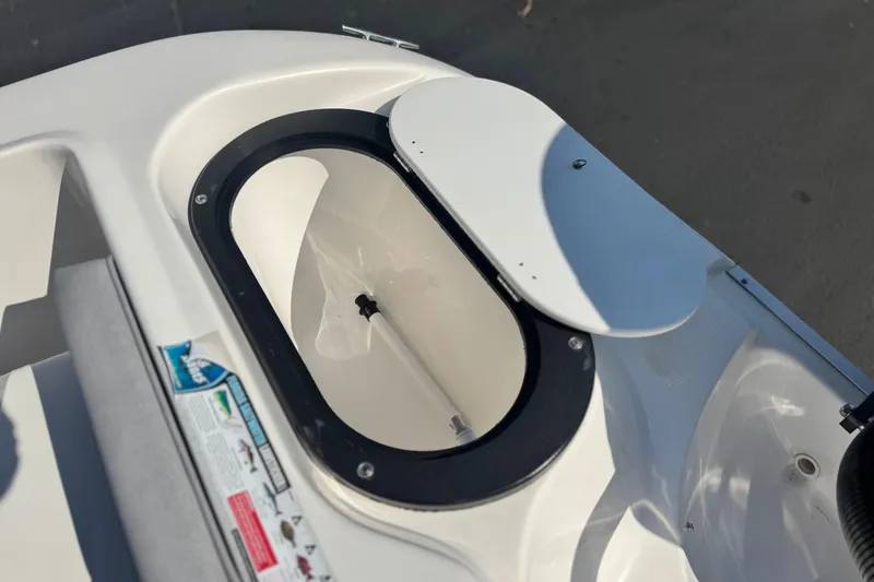 Slide: The Image of Open storage compartment on 2023 Key Largo 2001 CC boat, featuring a sleek white design. - 23