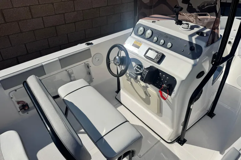 Slide: The Image of Key Largo 2001 CC 2023 boat interior with steering console and seating. - 24