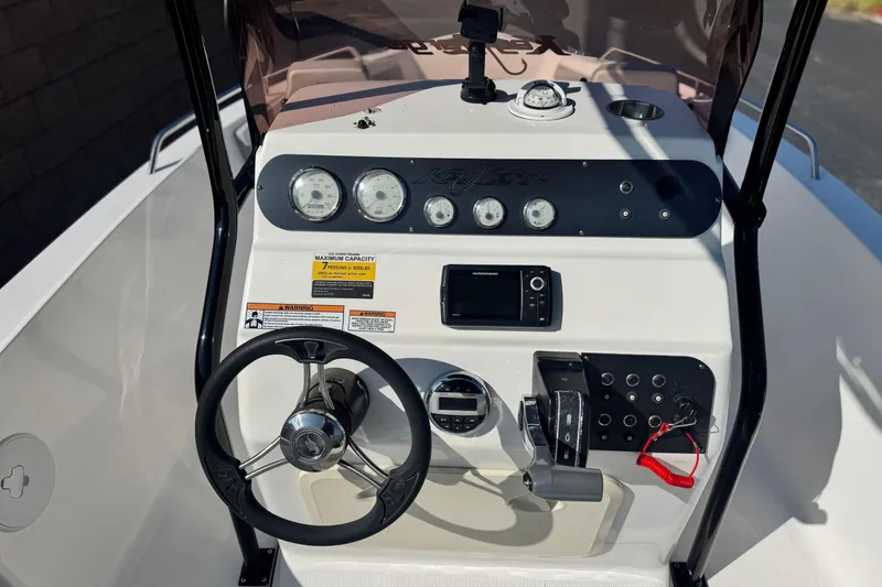 Slide: The Image of Center console of a 2023 Key Largo 2001 CC boat with steering wheel and gauges. - 25
