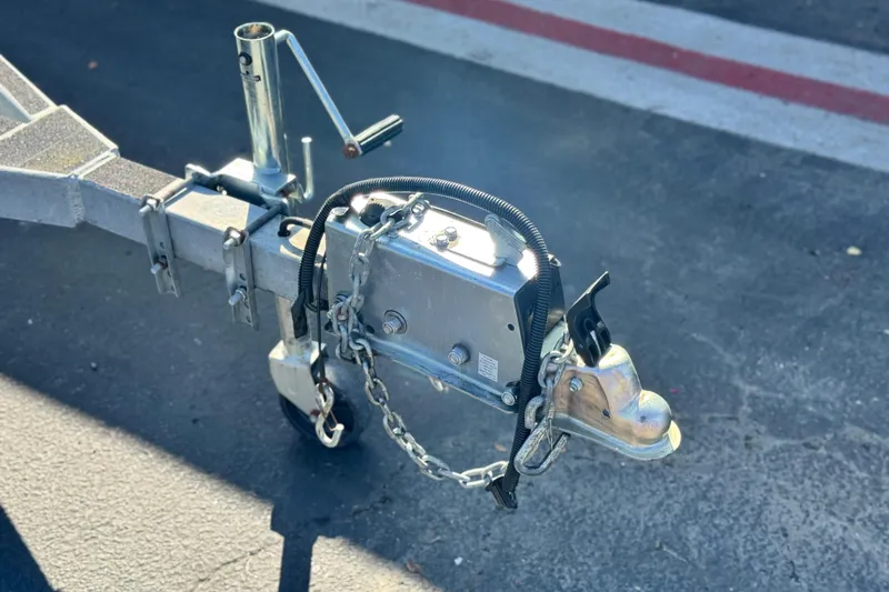 Slide: The Image of Trailer hitch of a 2023 Key Largo 2001 CC boat on asphalt surface. - 28