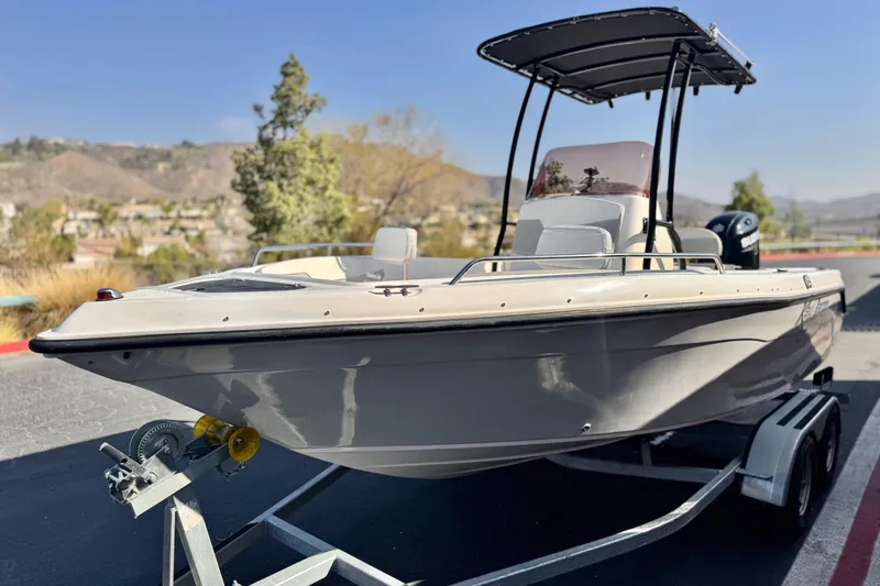 Slide: The Image of 2023 Key Largo 2001 CC boat on trailer, scenic background. - 3
