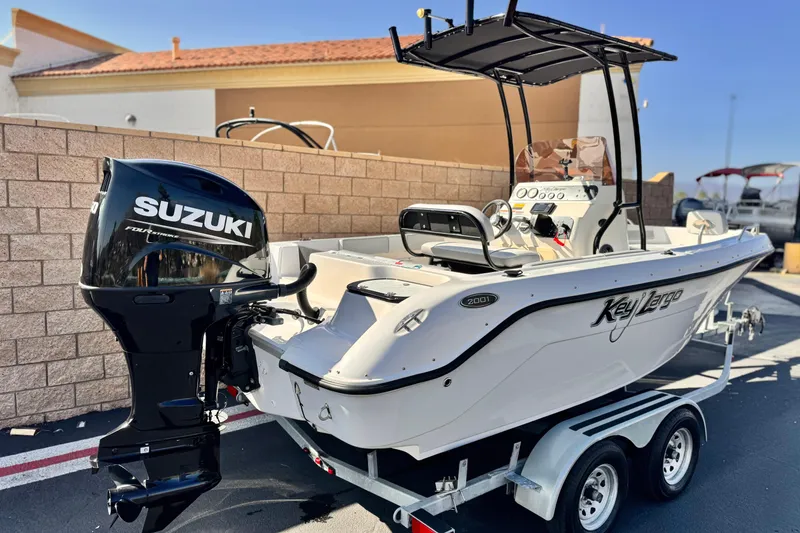 Slide: The Image of Key Largo 2001 CC boat, 2023 model, with Suzuki outboard motor on trailer. - 5