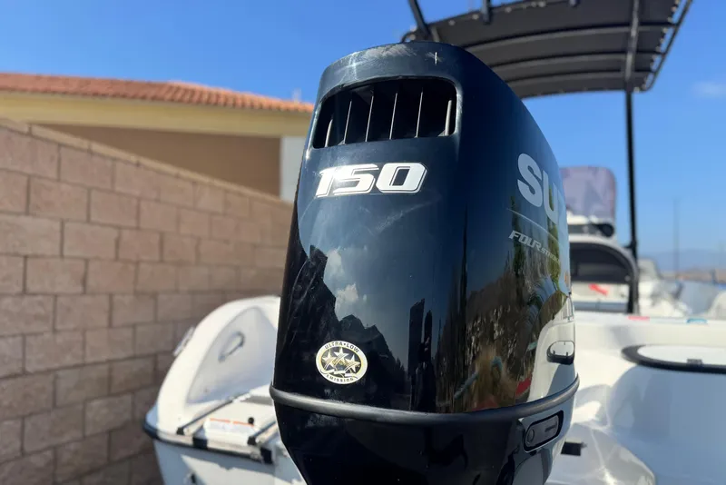 Slide: The Image of Key Largo 2001 CC boat with Suzuki 150 outboard motor, 2023 model, sunny day. - 7