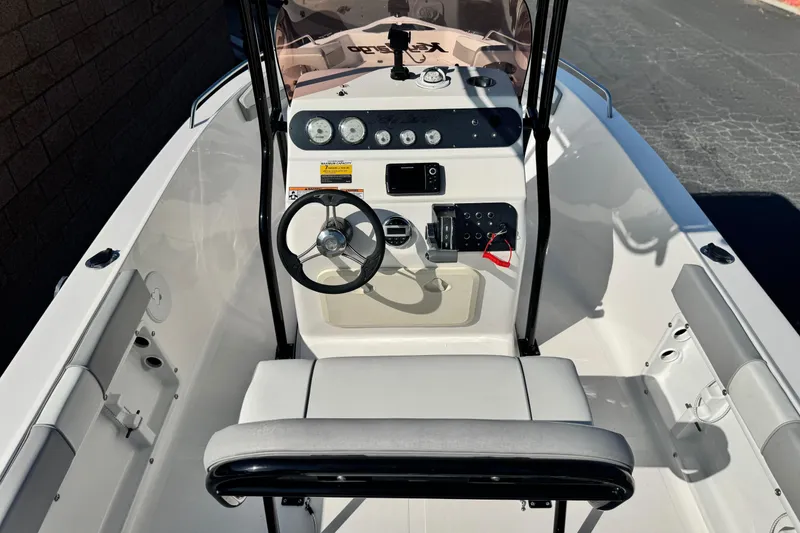 Slide: The Image of Center console of a 2023 Key Largo 2001 CC boat, featuring steering wheel and controls. - 8