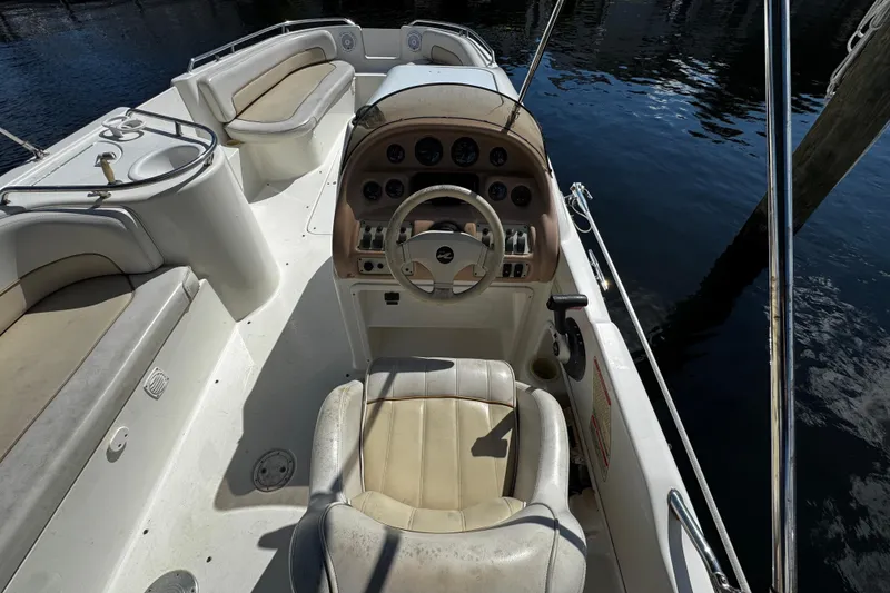 Slide: The Image of Throttle control on a 1996 Sea Ray 240 Sundeck boat, docked by the water. - 10