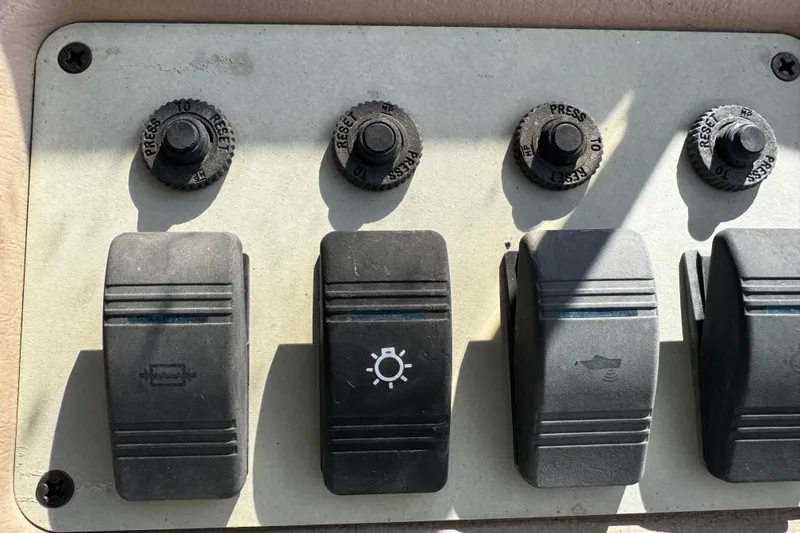 Slide: The Image of 1996 Sea Ray 240 Sundeck boat interior detail with seating and control panel. - 13