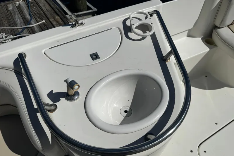 Slide: The Image of 1996 Sea Ray 240 Sundeck boat ladder and anchor compartment, showing wear and marine growth. - 16