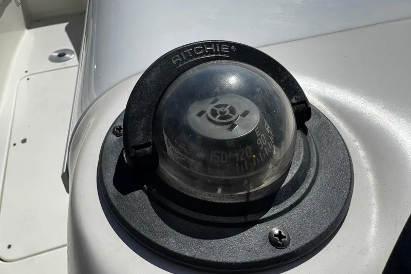 Slide: The Image of 1996 Sea Ray 240 Sundeck boat interior with seating, docked at marina. - 17