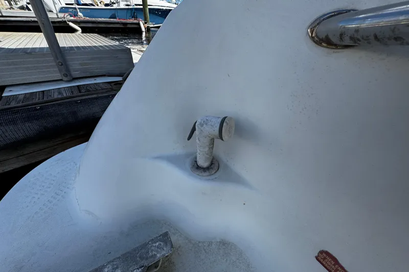 Slide: The Image of 1996 Sea Ray 240 Sundeck boat detail, featuring a deck fitting and railing. - 2