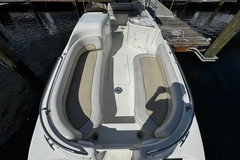 Slide: The Image of 1996 Sea Ray 240 Sundeck boat docked with green canopy, named "Time Out." - 22