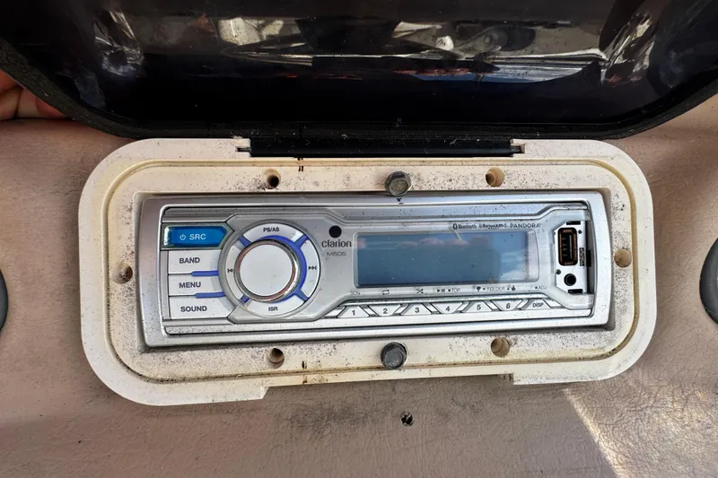 Slide: The Image of 1996 Sea Ray 240 Sundeck boat docked with green canopy, sunny day. - 23