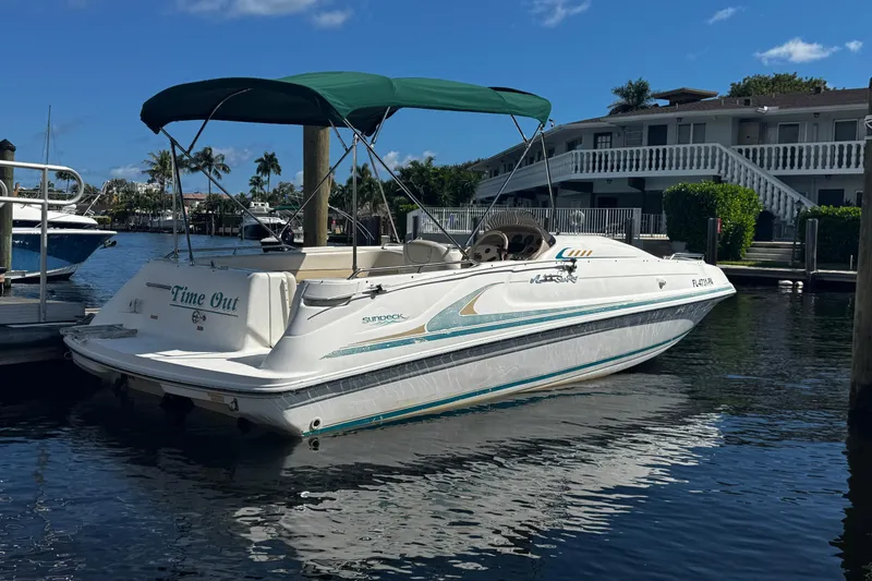 Slide: The Image of 1996 Sea Ray 240 Sundeck boat docked at marina under clear blue sky. - 26