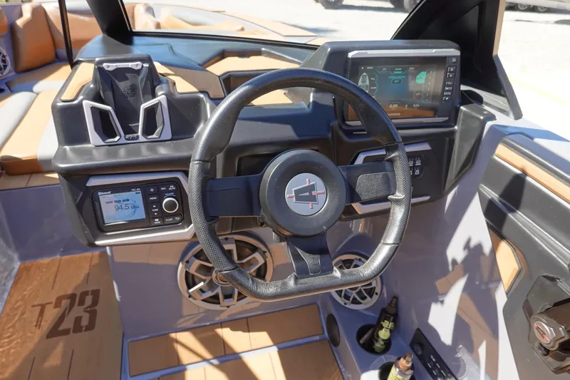 Slide: The Image of 2022 Axis T23 boat dashboard with steering wheel, digital displays, and audio controls. - 10