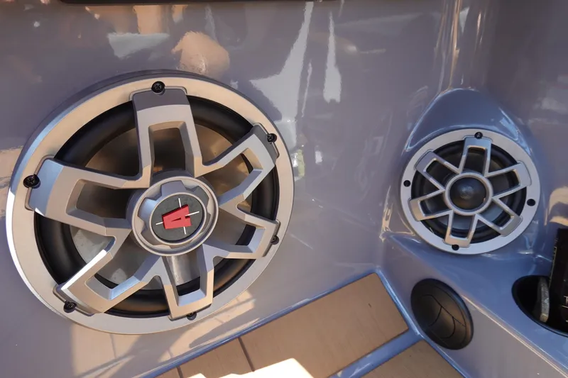 Slide: The Image of 2022 Axis T23 boat speakers with sleek metallic design and modern audio setup. - 12