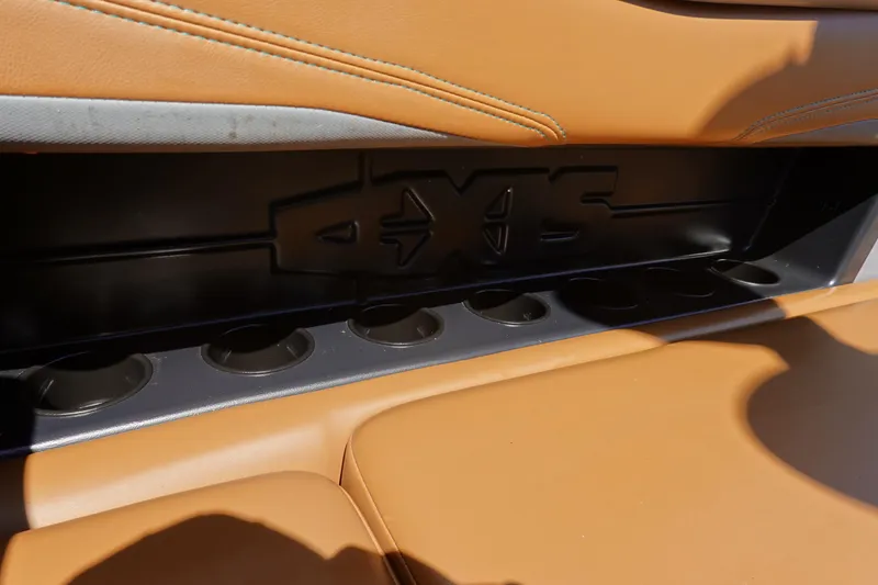 Slide: The Image of 2022 Axis T23 boat interior with tan leather seats and cup holders. - 16