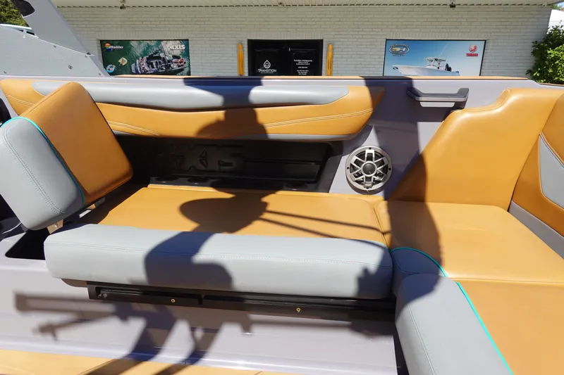 Slide: The Image of 2022 Axis T23 boat interior with tan and gray seating, speaker, and modern design. - 17