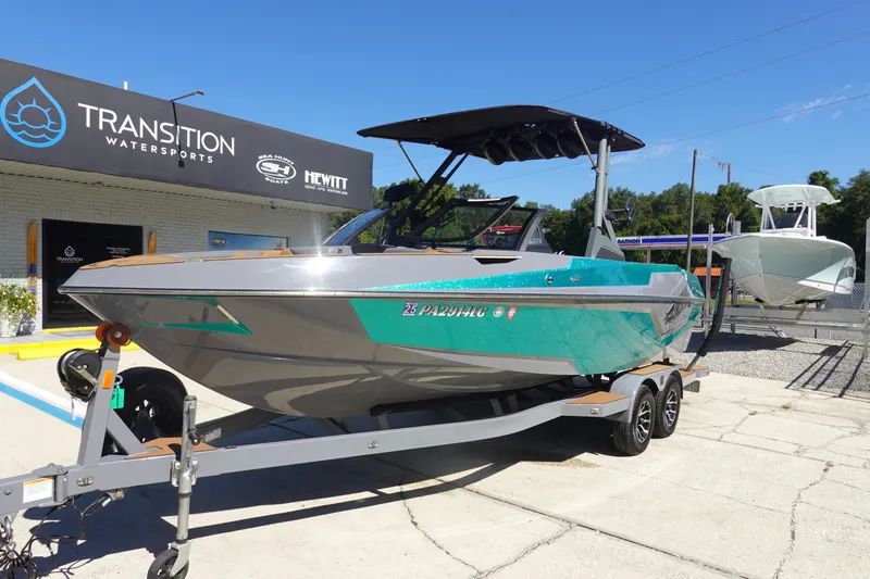 Slide: The Image of 2022 Axis T23 boat on trailer at Transition Watersports dealership. - 2