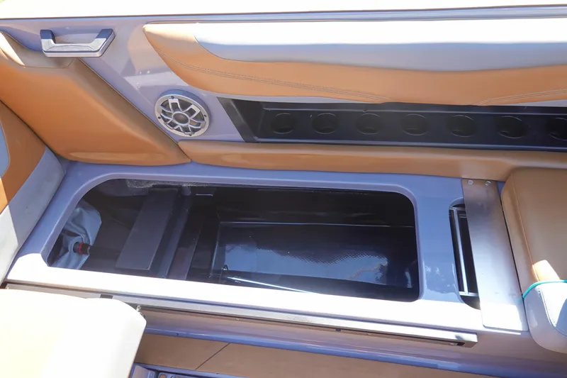 Slide: The Image of 2022 Axis T23 boat interior with storage compartment and speaker system. - 20