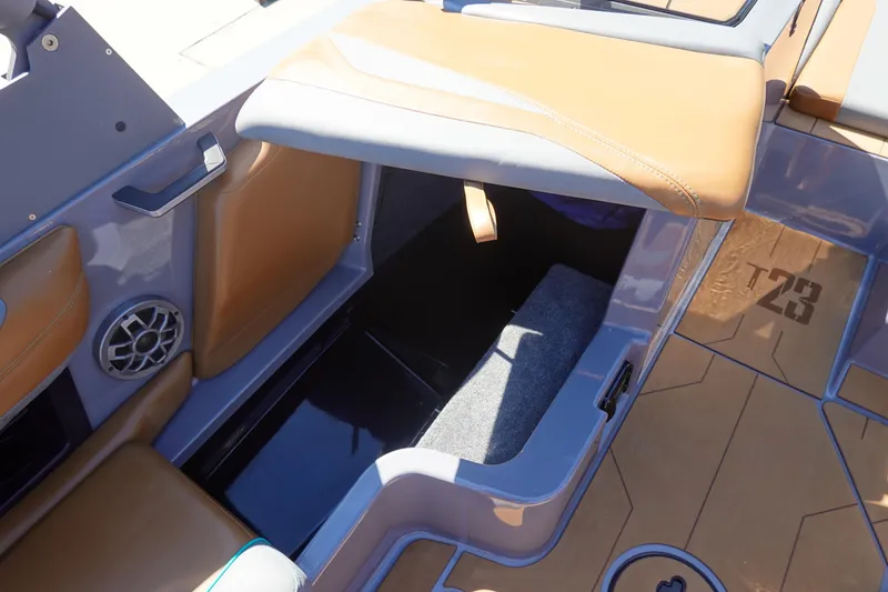 Slide: The Image of 2022 Axis T23 boat interior with storage compartment and speaker. - 23