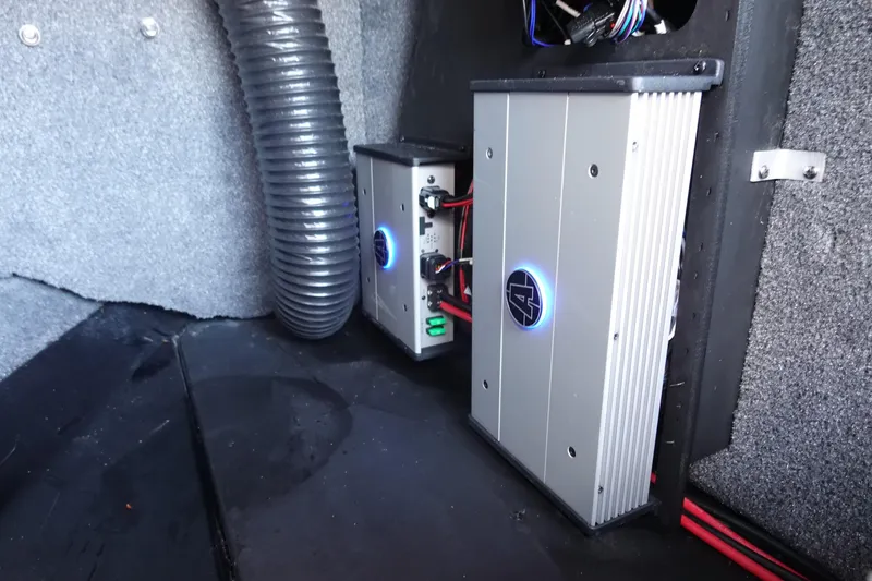 Slide: The Image of 2022 Axis T23 interior showing installed audio amplifiers and wiring setup. - 24