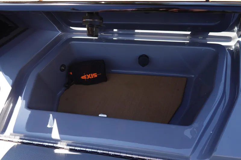 Slide: The Image of 2022 Axis T23 boat storage compartment with branded bag inside. - 26