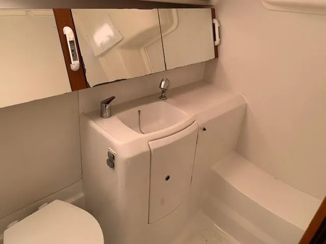 Slide: The Image of Bathroom interior of 2013 Beneteau Oceanis 37 yacht, featuring sink and mirror cabinet. - 12