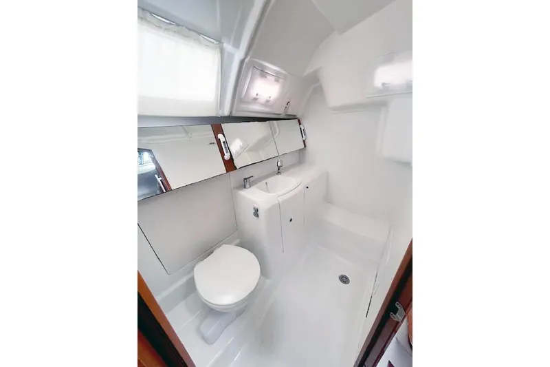 Slide: The Image of Bathroom interior of 2013 Beneteau Oceanis 37 yacht, featuring modern fixtures and white decor. - 15