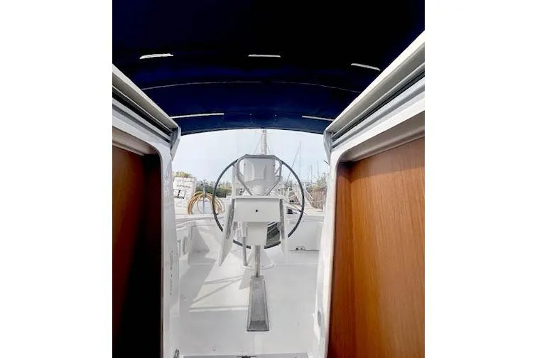 Slide: The Image of 2013 Beneteau Oceanis 37 cockpit view with steering wheel and canopy. - 4