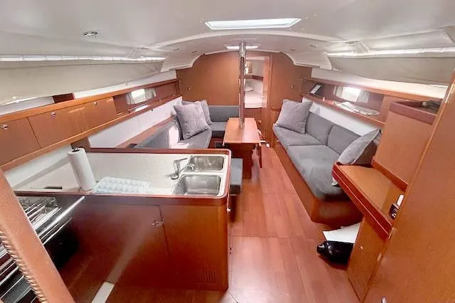 Slide: The Image of Interior of 2013 Beneteau Oceanis 37 sailboat with cozy seating and modern kitchen area. - 5