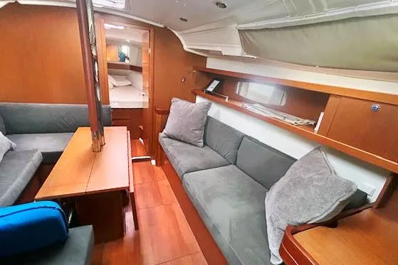 Slide: The Image of Interior of 2013 Beneteau Oceanis 37 yacht with cozy seating and wooden finishes. - 7