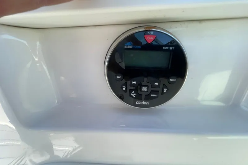 Slide: The Image of Clarion marine audio system on 2022 Chaparral 23 SSi boat dashboard. - 15