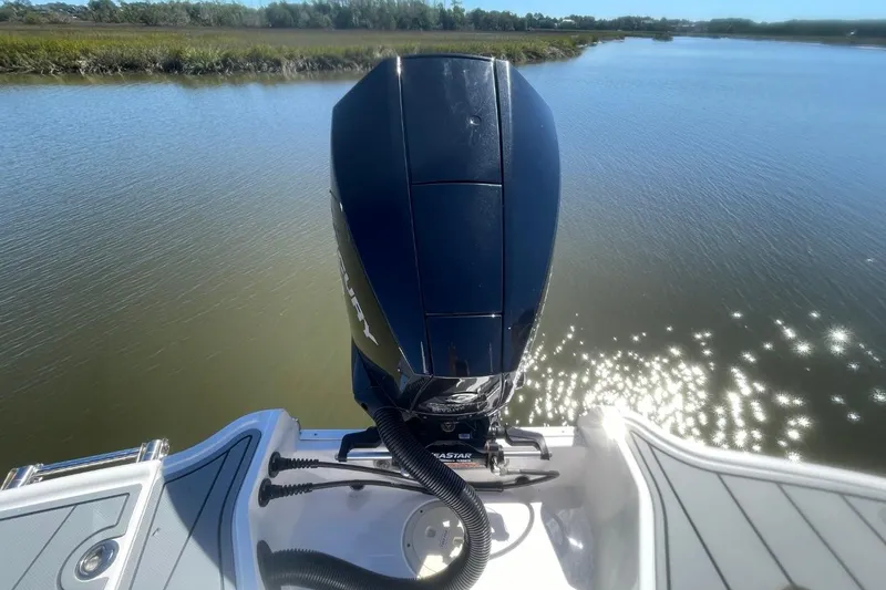 Slide: The Image of 2022 Chaparral 23 SSi boat with Mercury outboard engine on calm water. - 19