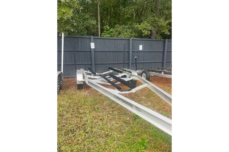 Slide: The Image of Trailer for 2022 Chaparral 23 SSi boat parked on grass near a fence. - 22