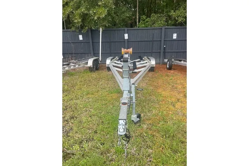 Slide: The Image of Trailer for 2022 Chaparral 23 SSi boat on grassy lot. - 23