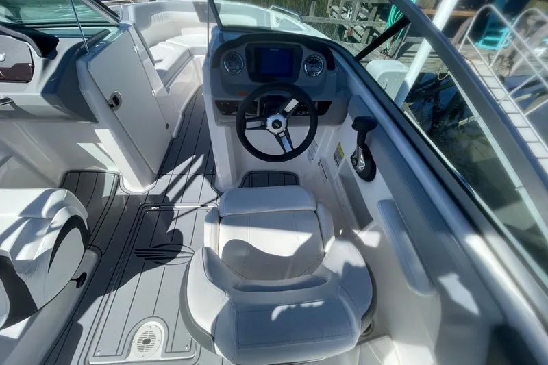 Slide: The Image of 2022 Chaparral 23 SSi boat interior with steering wheel and seating. - 8