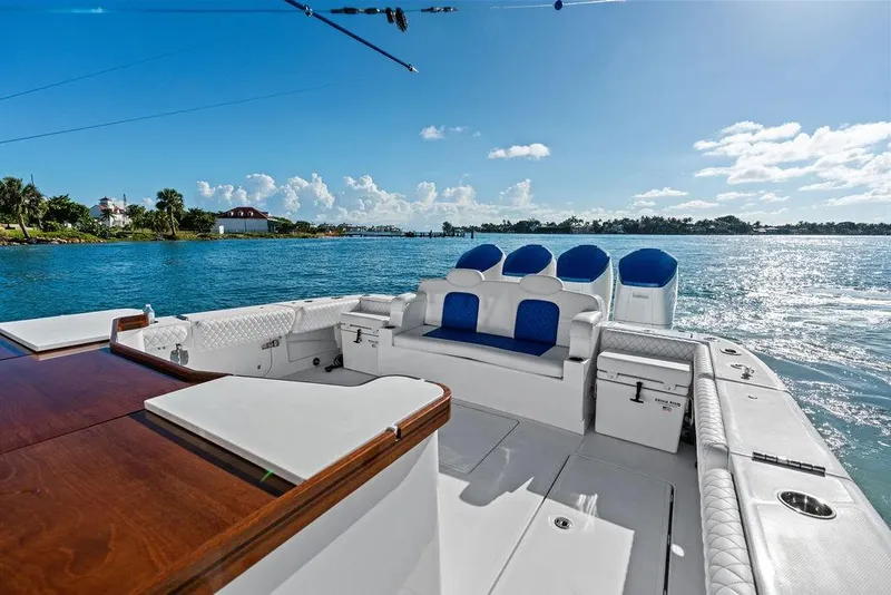 Slide: The Image of Luxury 2025 HCB 53 Suenos RXV boat on serene blue waters, featuring elegant seating. - 13