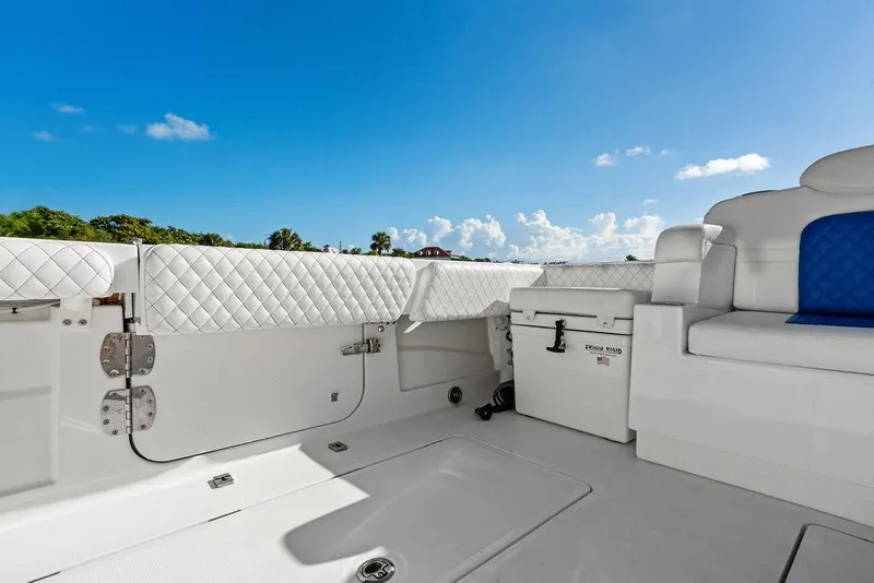 Slide: The Image of 2025 HCB 53 Suenos RXV boat interior with white quilted seating and blue accents. - 16