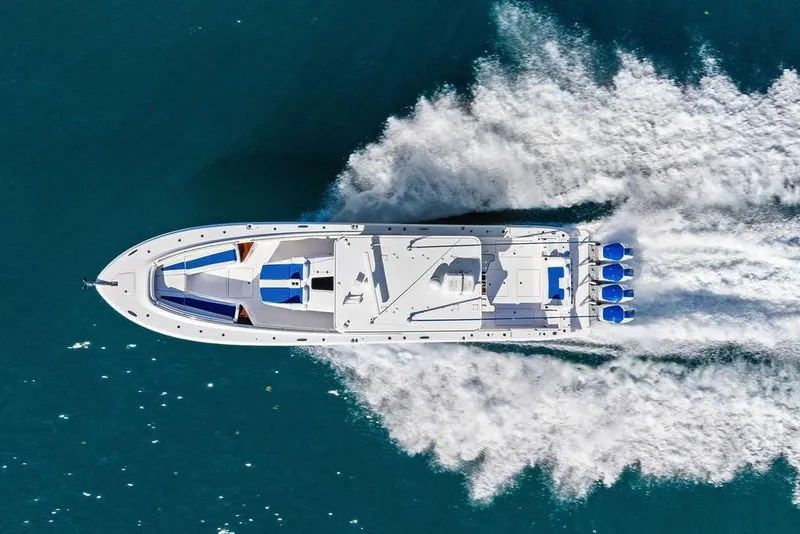 Slide: The Image of Aerial view of 2025 HCB 53 Suenos RXV speedboat cruising on blue water. - 2