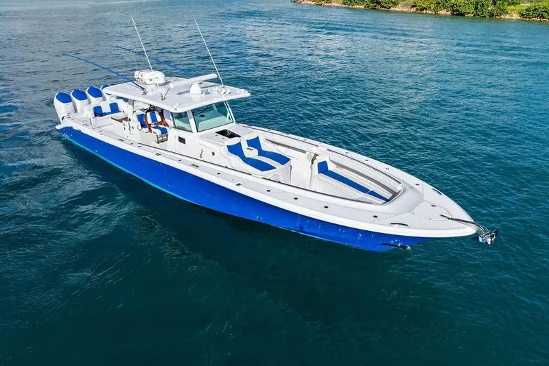 Slide: The Image of 2025 HCB 53 Suenos RXV boat on clear blue water, showcasing sleek design and powerful engines. - 5