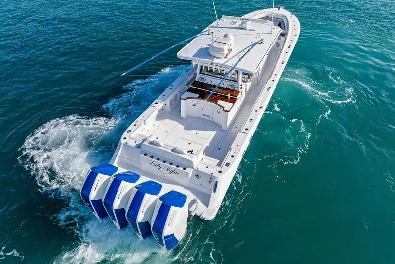 Slide: The Image of 2025 HCB 53 Suenos RXV boat cruising on clear blue water. - 8