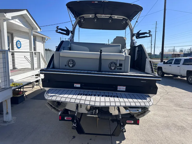 Slide: The Image of 2026 Montara Surf Boss 2.0 SL 23" boat, rear view with seating and sleek design. - 2