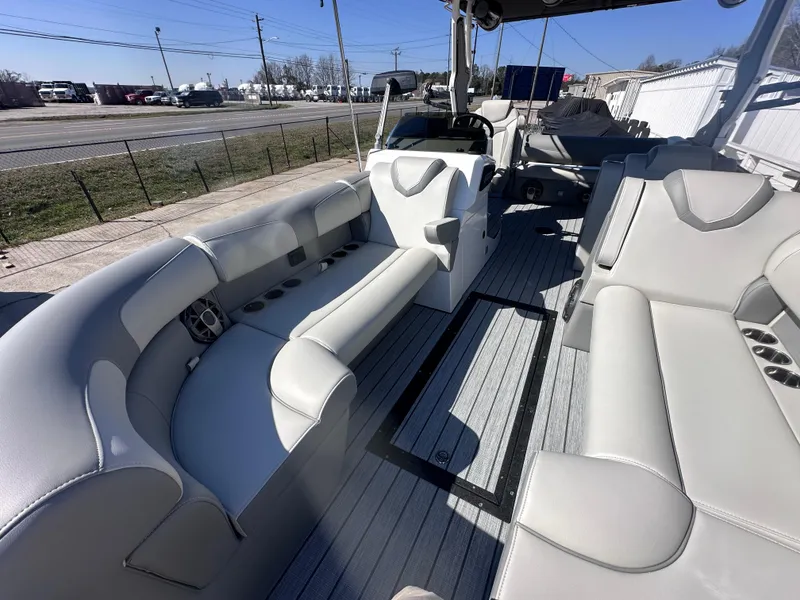 Slide: The Image of 2026 Montara Surf Boss 2.0 SL 23" boat, sleek design, docked near a house. - 4