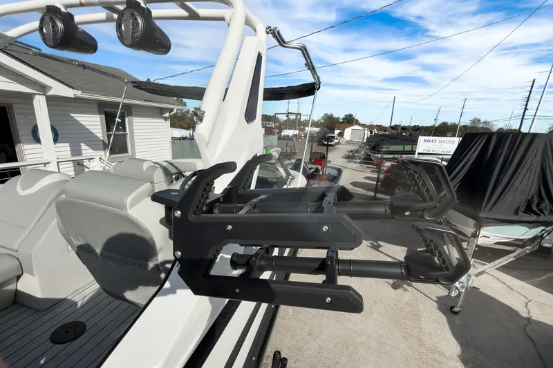 Slide: The Image of 2026 Montara Surf Boss 2.0 SL 23" boat with black canopy, parked near a road. - 43