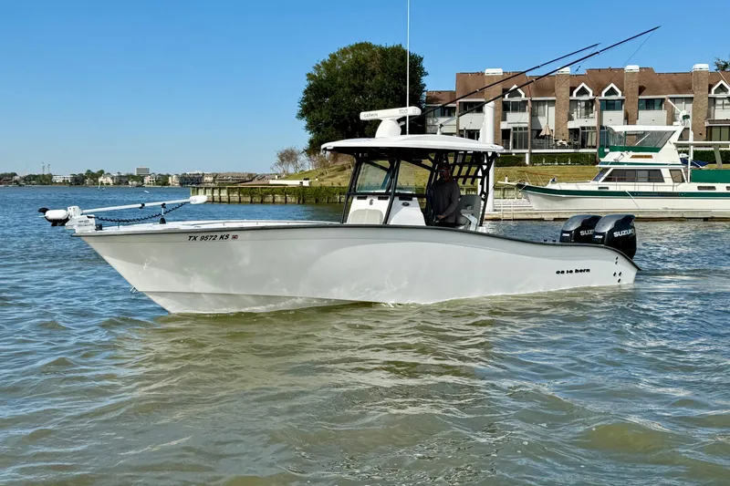 The Image of 2022 Cape Horn 31 T boat on water near residential area, clear sky. - 0