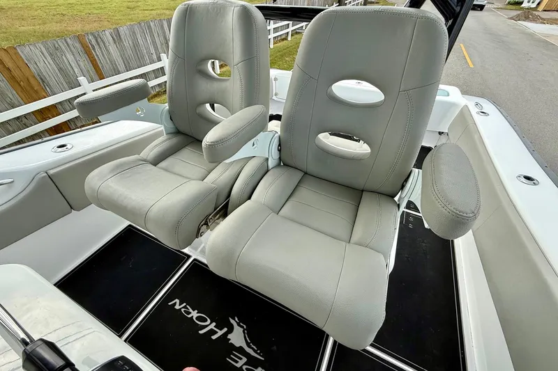 Slide: The Image of 2022 Cape Horn 31 T boat on trailer, parked on roadside under clear blue sky. - 10