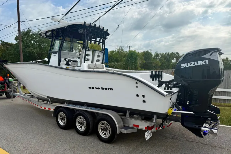 Slide: The Image of 2022 Cape Horn 31 T boat with dual 350 engines on a lake near waterfront homes. - 2